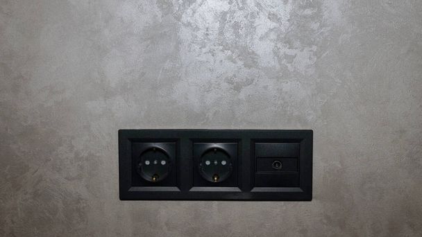 Electrical outlet on a gray Venetian wall. Antenna for tv in the form of a socket, antenna socket - Фото, зображення