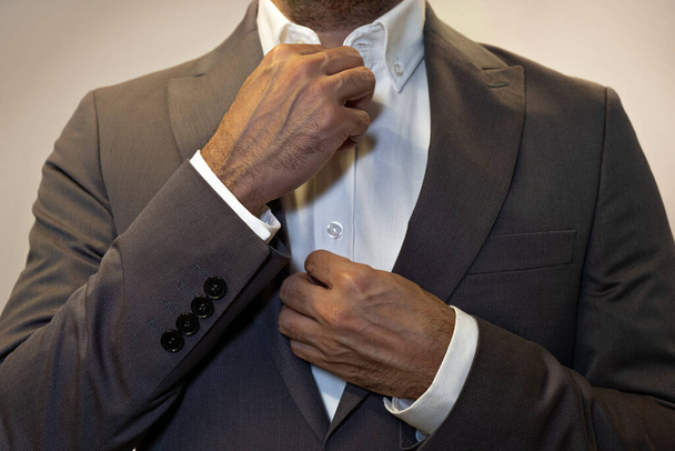 cropped portrait businessman,fashion. man in white shirt and suit button with hands - Fotoğraf, Görsel