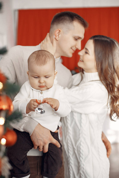 Family in Christmas clothes at home - Foto, imagen
