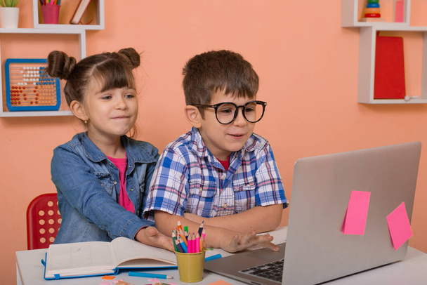 Τα παιδιά μαθαίνουν online στο σπίτι. Διδασκαλία κατ 'οίκον και εξ αποστάσεως εκπαίδευση για παιδιά. Girl and student study online με τον δάσκαλο βιντεοκλήσεων - Φωτογραφία, εικόνα