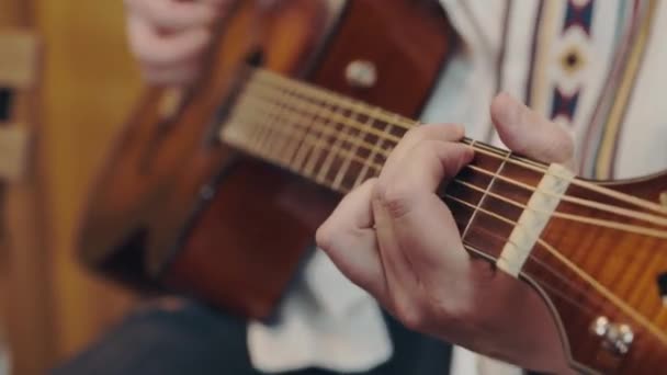 male hand rearranges chords on acoustic guitar close up. - Footage, Video