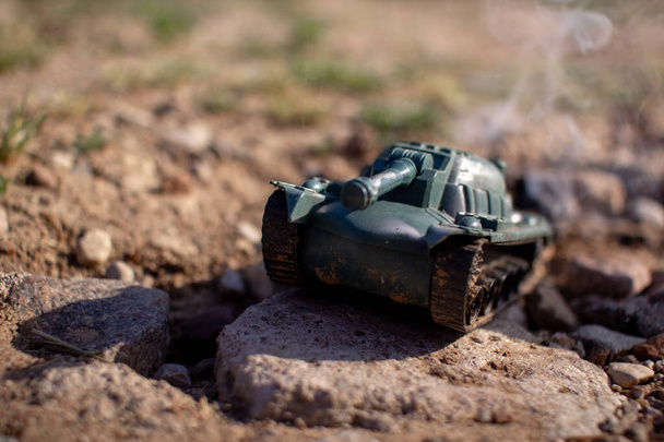 Toy plastic tank driving on the road and smoking - Photo, Image