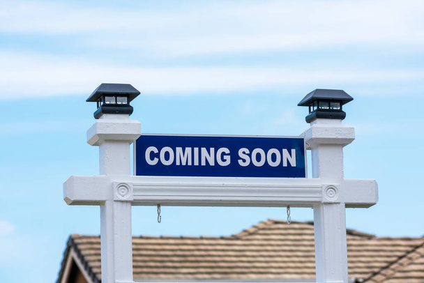 Coming Soon sign in front of a house for sale in a residential neighborhood. - Photo, Image