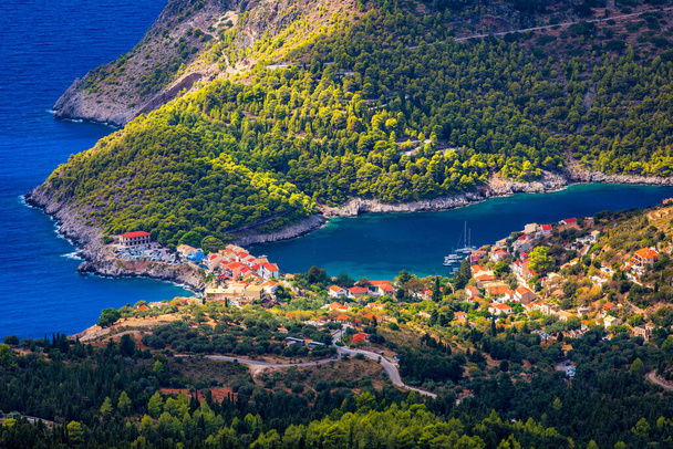 Assos village in Kefalonia, Greece. Turquoise colored bay in Mediterranean sea with beautiful colorful houses in Assos village in Kefalonia, Greece, Ionian island, Cephalonia, Assos village. - Photo, Image