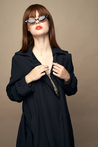 Attractive woman black coat self-confidence having fun studio - Photo, Image