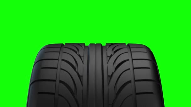 Loop Spinning car wheel on a green background - Footage, Video
