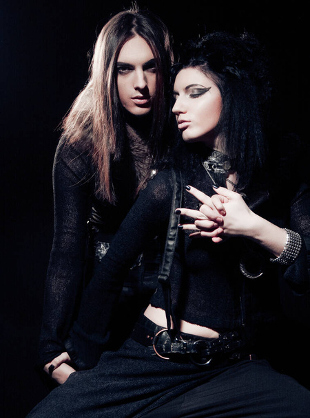Romantic portrait of young gothic couple - man and woman over dark background. - Photo, image