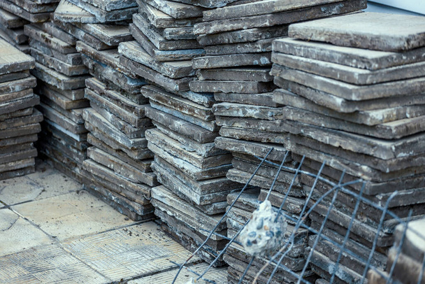 Used paving slabs have been dismantled and stacked.  - Photo, Image