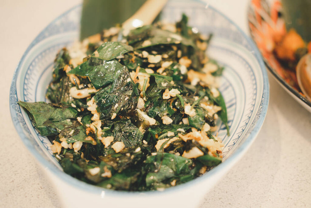 Stir-fried Baegu leaves with egg or Gnetum gnemon or Malindjo. This menu is favorite in the south of Thailand - 写真・画像