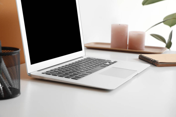 Modern laptop on white table - 写真・画像