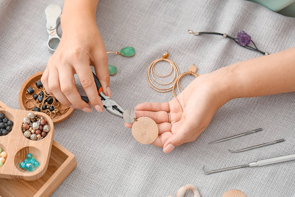 Female designer making jewelry at workplace - Fotoğraf, Görsel