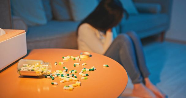 Asian girl feel depressed and overdose medicine alone at home - Foto, imagen