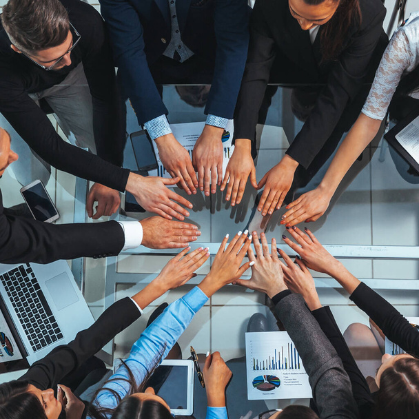 top view. business team joining their hands in a circle - Fotografie, Obrázek