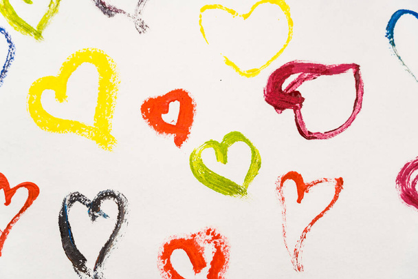 Multi-colored hearts drawn by paints on a white background. Valentine's day card - Фото, зображення