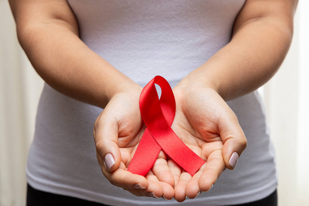 30 year old woman showing red ribbon - Foto, Bild