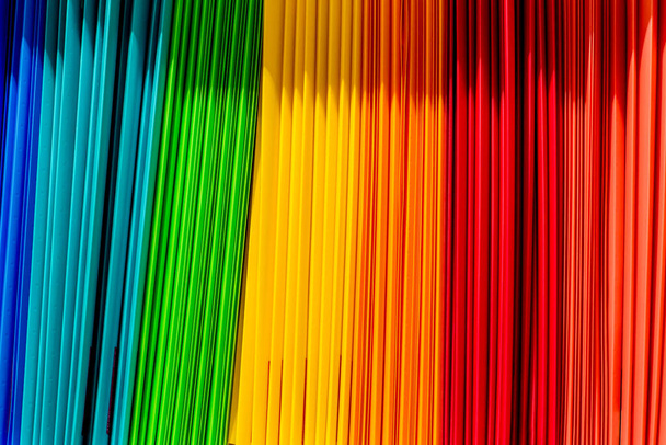 Πίσω στο σχολικό υπόβαθρο. Χρώματα ουράνιο τόξο των πλαστικών φακέλων εγγράφων συνδετικά σε χαρτοπωλείο - Φωτογραφία, εικόνα