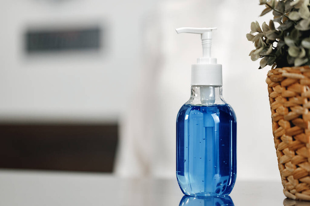Antibacterial hand sanitizer gel on hotel front desk - Fotoğraf, Görsel