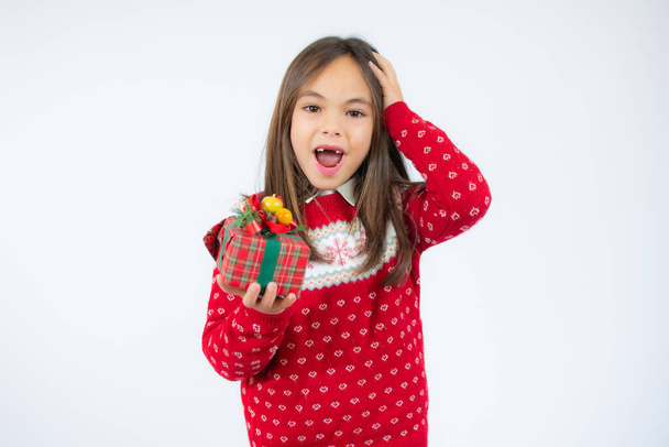Fröhliches kleines Mädchen hält Geschenkbox in den Händen über weißem Hintergrund. - Foto, Bild