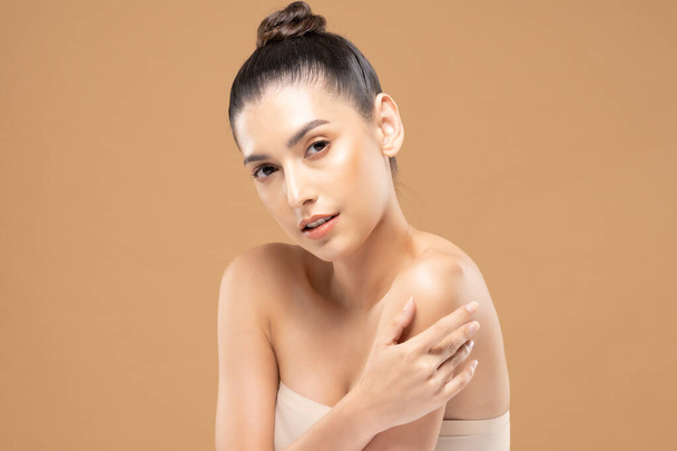 Beautiful Glamour woman touch shoulder smile with clean and fresh skin Happiness and cheerful with positive emotional,isolated on Beige background,Beauty Cosmetics and spa Facial treatment Concept - 写真・画像