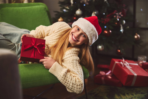Smiling girl spending happy Boxing Day at home - Foto, Imagen