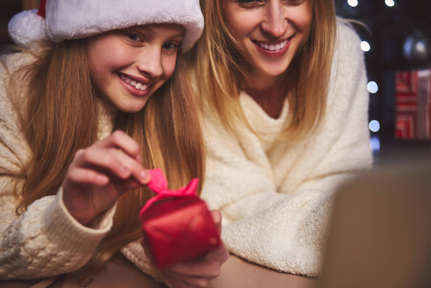 Cheerful female preparing for Christmas with daughter - Fotó, kép