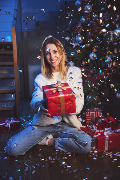 Happy attractive woman receiving gift for Christmas - Foto, imagen