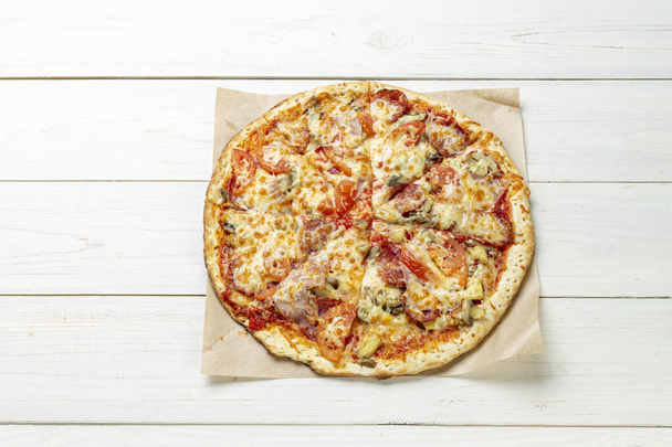 Delicious pizza on white wooden table. Pizza delivery. Pizza menu. Space for text. View from above.  - Фото, изображение