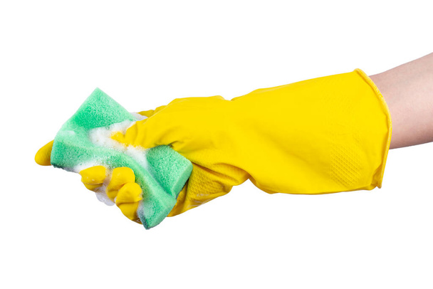 Cleaning concept - hand in a yellow rubber glove holds a green sponge isolated on white background. - Φωτογραφία, εικόνα