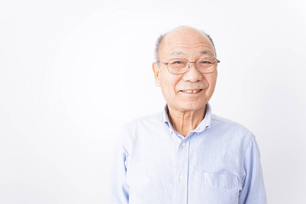 Senior man is smiling on white background - Valokuva, kuva