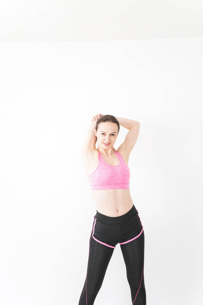 Young woman wearing sportswear stretching - Fotografie, Obrázek