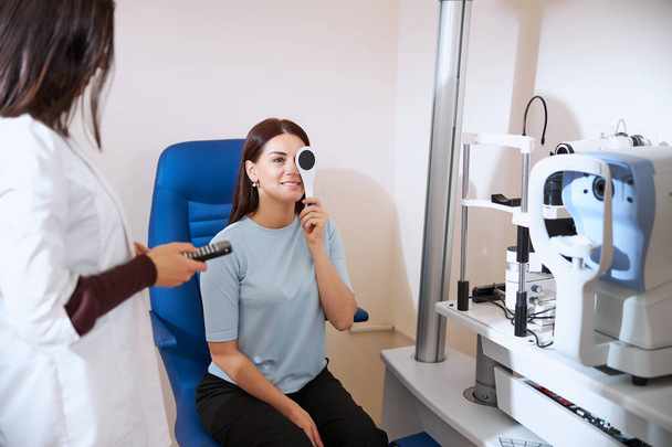 Lady using an occluder while checking her eyesight - Photo, Image