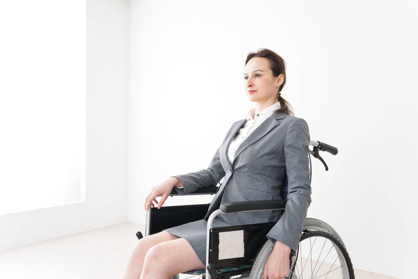 Young woman working in a wheelchair - Photo, Image