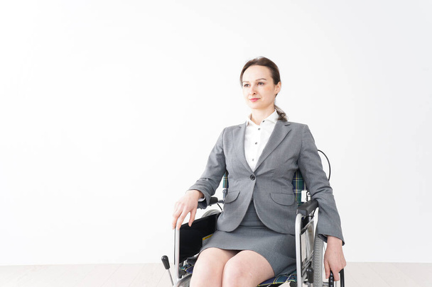 Young woman working in a wheelchair - Zdjęcie, obraz