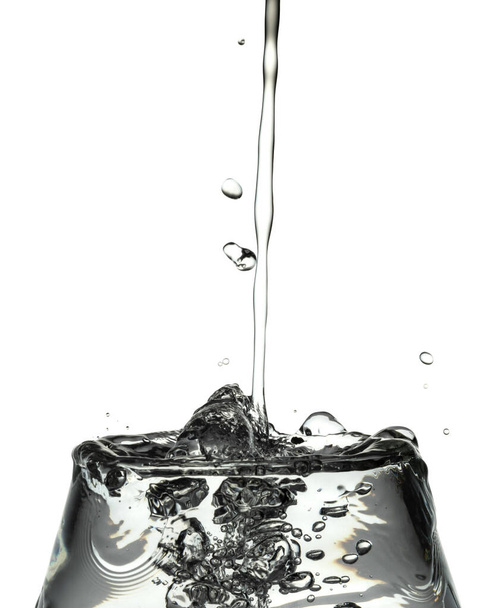 Drop of frozen water falling and making a realistic and natural splash. - Photo, image