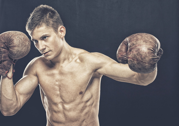 Guy with old boxing gloves - Foto, imagen