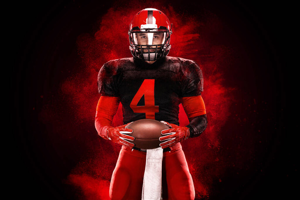 American football player, athlete sportsman in red helmet on black background. Sport poster. Motivation wallpaper. - Foto, Imagen