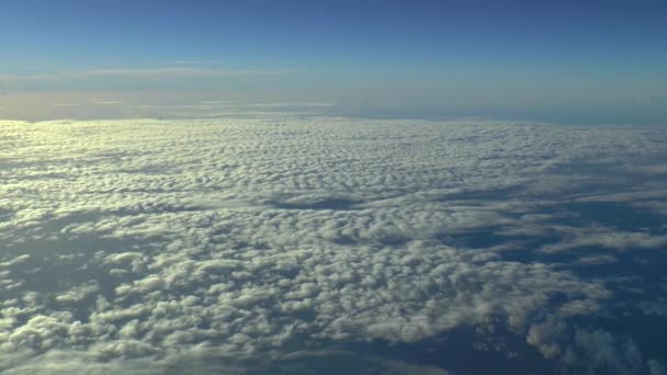 Repül a felhők felett egy kereskedelmi repülőn. Tényleges nagy magasságú felvételek. - Felvétel, videó