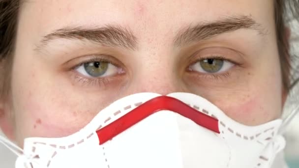 Close-up portret van vrouwelijke arts kijken in de camera zetten op beschermende bril, pak en masker. Bestrijding van wereldwijde pandemie en covid-19 - Video