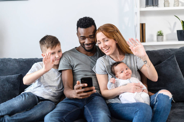 A multiracial family on the couch at home - Foto, immagini