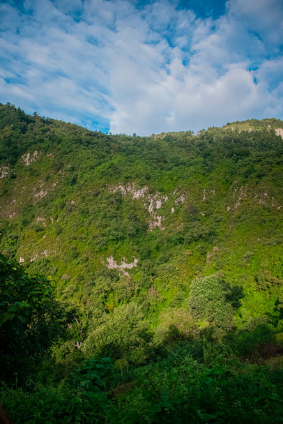 ravine with hill and white clouds - Photo, Image