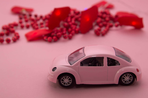 pink car, red beads and hearts on a pink background.valentines day, mothers day, womens day. - Photo, image