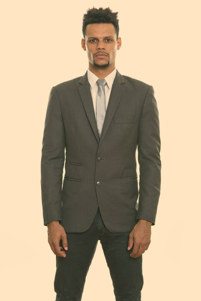 Studio shot of young African businessman standing - Photo, Image
