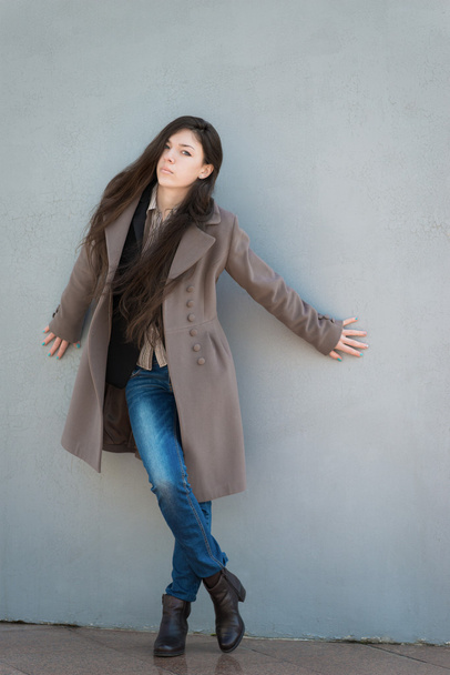 Young girl in coat. - Foto, afbeelding