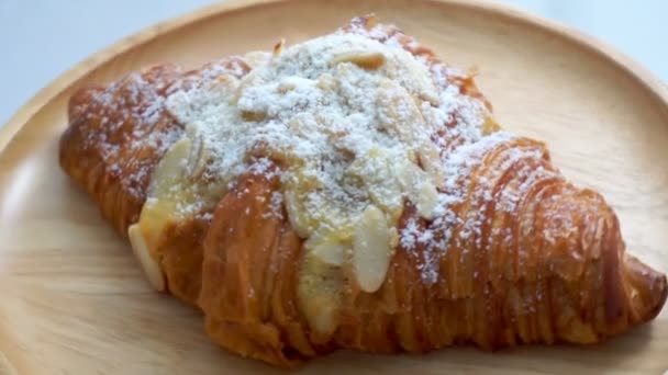 The croissants with almond and milk on the wooden plate are spinning. - Footage, Video