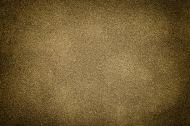 Dark beige matte background of suede fabric with vignette, closeup. Velvet texture of seamless brown textile with gradient, macro. Structure of sand felt canvas backdrop. - Photo, Image