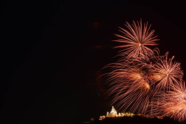 Fireworks over buddhist temple at night time - Photo, Image