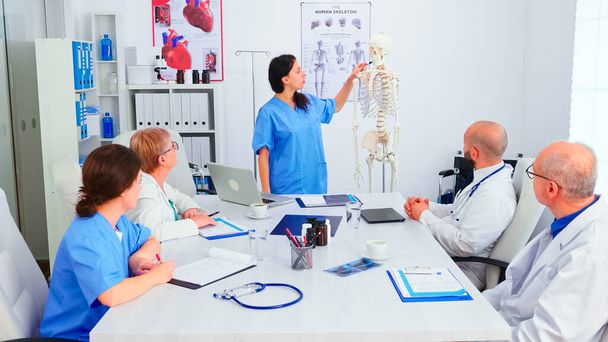 Nurse giving presentation using skeleton model - Photo, Image