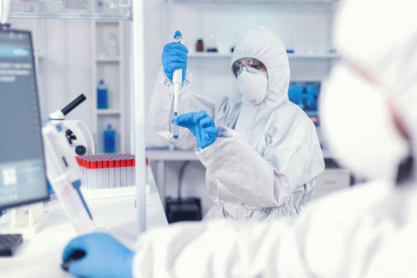 Healthcare doctor taking sample from test tube using micropipette - Fotografie, Obrázek