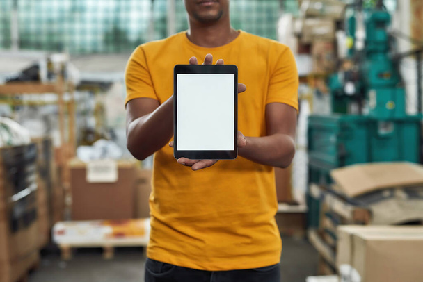 Digital tablet held by man inside garbage station - Foto, Imagem