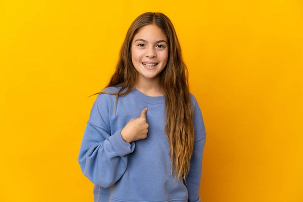 Child over isolated yellow background with surprise facial expression - Photo, image